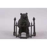 A C19th finely cast patinated bronze inkwell in the form of a bear behind railings, 12cm high