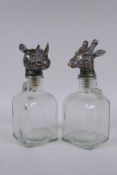 A pair of glass decanters with gilt composition stoppers in the form of animal heads, 25cm high