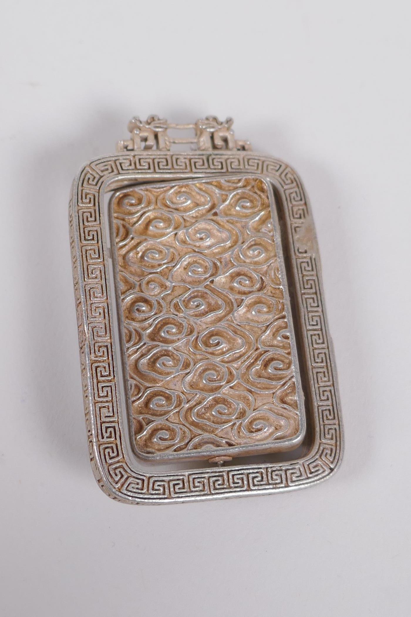 A Chinese white metal and jade set pendant with revolving panel depicting buddha, 6cm x 4cm - Image 2 of 2