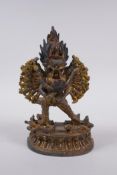 A Tibetan gilt metal figure of Hevajra and Nairatmya, 19cm high