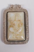 A Chinese white metal and jade set pendant with revolving panel depicting buddha, 6cm x 4cm