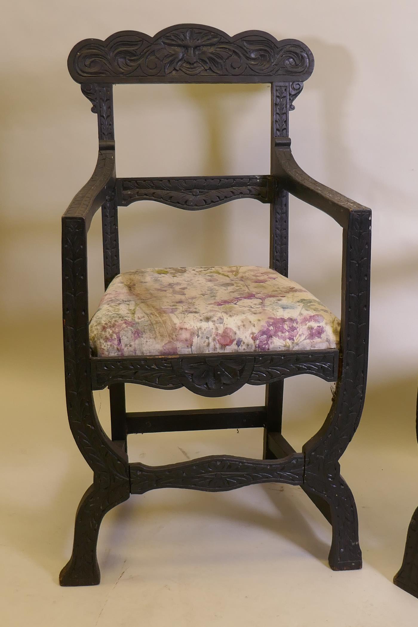 A pair of C19th ebonised X frame chairs with carved Green Man decoration and drop in seats - Image 3 of 4