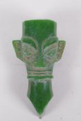 An oriental reconstituted green hardstone archaic style head, 14cm