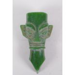 An oriental reconstituted green hardstone archaic style head, 14cm