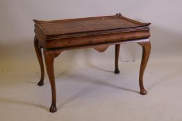 A figured walnut occasional table, with shaped gallery and cushion shaped frieze, raised on cabriole