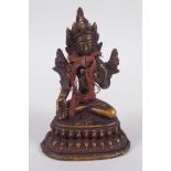 A Tibetan bronze figure of Buddha seated on a lotus throne, 10cm high