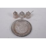 An Indian high purity white metal three piece cruet with repousse decoration, marked T100 to base,