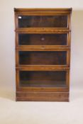 A Globe Wernicke oak bookcase, with four glazed sections, base section with drawer, and top, 86 x 30