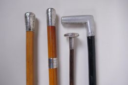 An 1891 silver topped walking cane, and another silver topped cane, a silver parasol handle and an