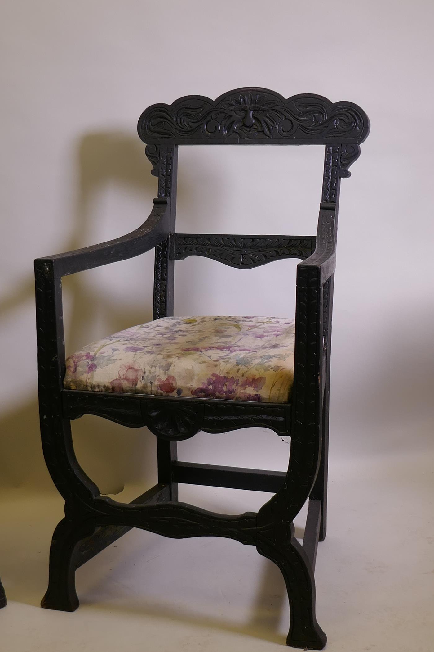 A pair of C19th ebonised X frame chairs with carved Green Man decoration and drop in seats - Image 2 of 4