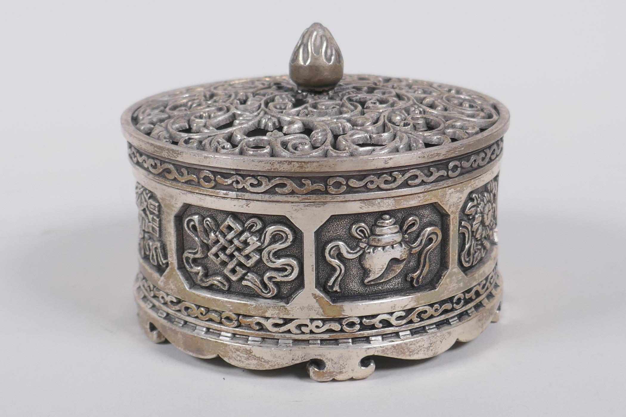 A Sino Tibetan white metal cylinder censer and cover, decorated with the emblems of the eight - Image 4 of 6