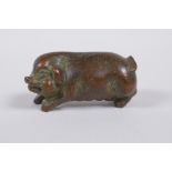 A Japanese style bronze okimono pig, 6cm long