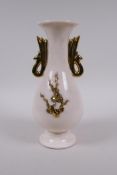 A Chinese blanc de chine porcelain vase with gilt handles and raised prunus  decoration, 26cm high