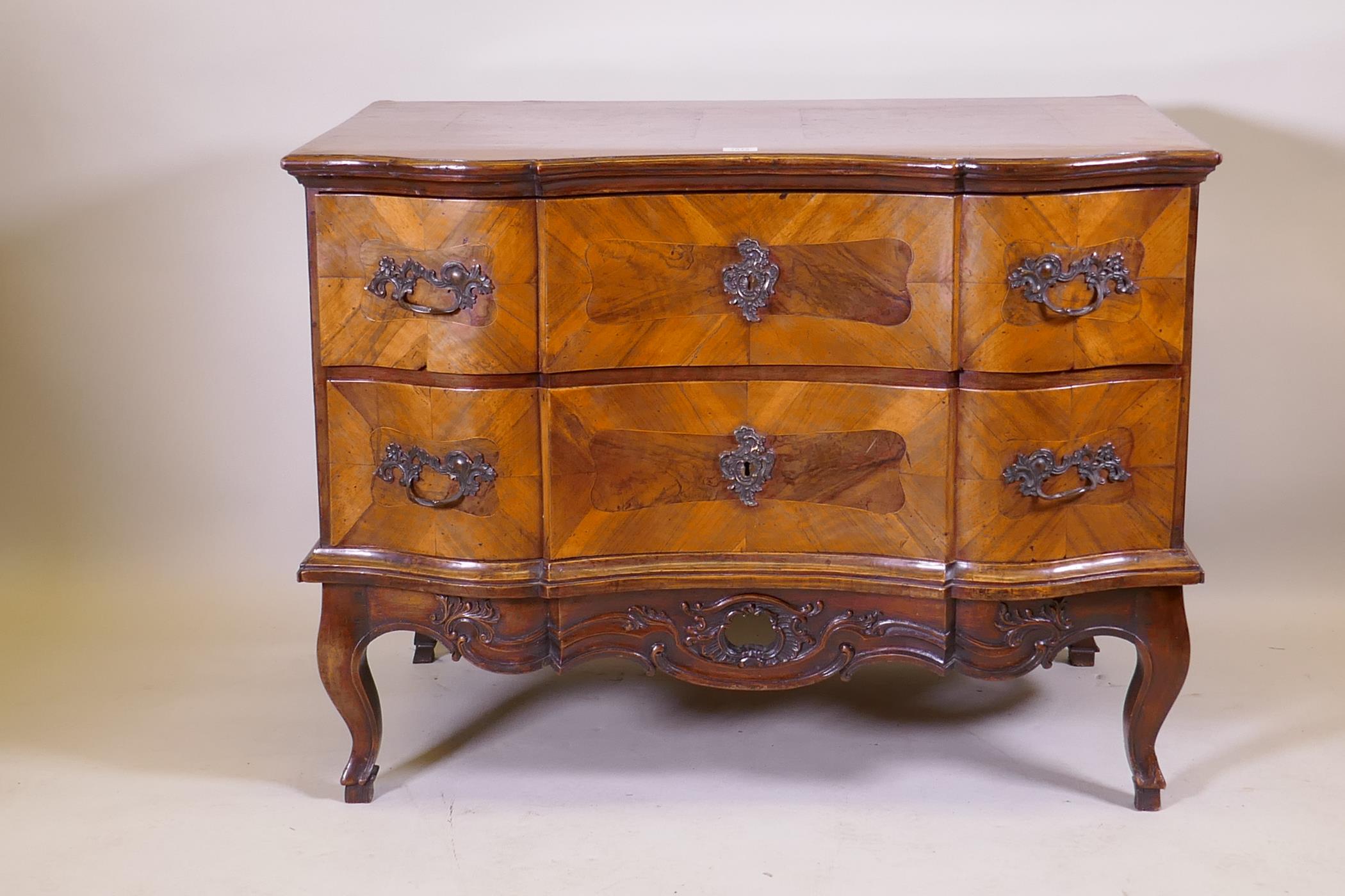 A late C18th/early C19th Maltese serpentine fronted walnut commode with two drawers, raised on a