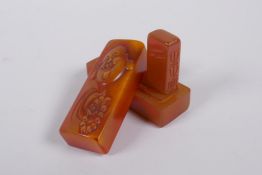 A Chinese soapstone box containing an amber style soapstone seal, the cover with carved Buddha