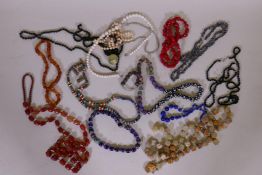 A string of agate beads, glass beads, enamelled and other necklaces