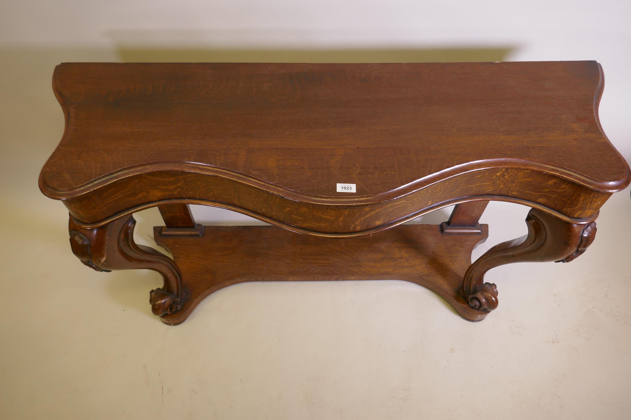 A Victorian oak serpentine console table on carved scrolled cabriole supports united by an under - Image 4 of 4