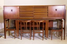 A mid century Elliott of Newbury teak credenza with sliding doors and three drawers, a pull out fold