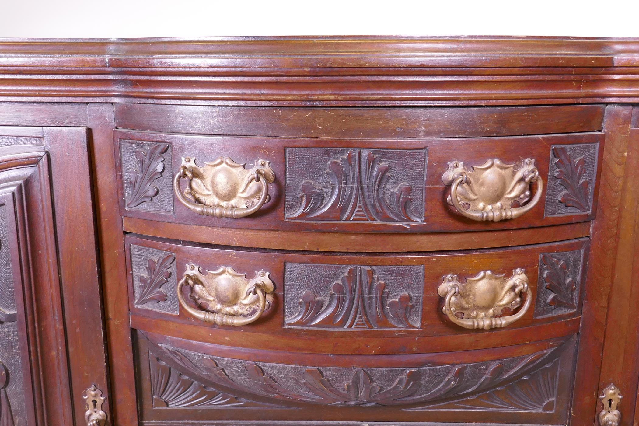 A Victorian walnut sideboard with carved decoration, two cupboards flanking two bow fronted drawers, - Image 3 of 5