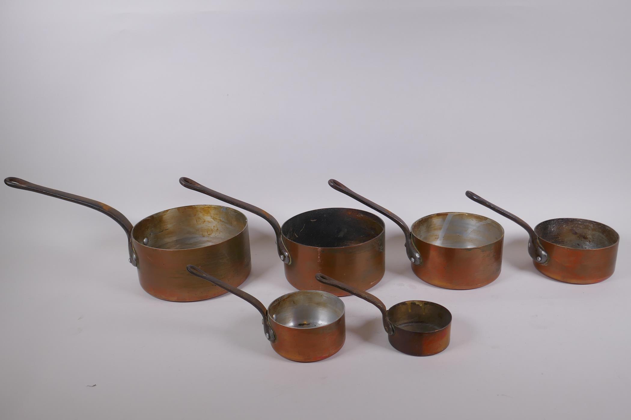 A set of six graduated French copper sauce pans, largest 18cm diameter