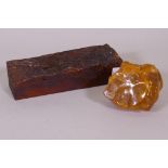 A natural amber specimen on tree bark, 26 x 8 x 7cm, and another, 10cm high