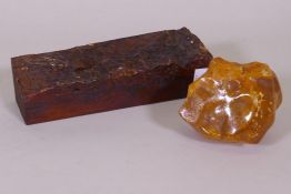 A natural amber specimen on tree bark, 26 x 8 x 7cm, and another, 10cm high