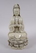 A Chinese blanc de chine porcelain Quan Yin seated on a lotus flower, impressed marks to the