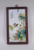 A Chinese famille vert porcelain panel in a hardwood frame, depicting birds and lotus flowers, 23