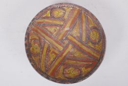 An Islamic terracotta bowl decorated with a unique design, AF repairs, 23cm diameter