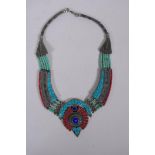 A Tibetan white metal necklace set with turquoise shards and coral, 40cm long