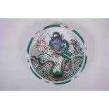 A famille vert porcelain bowl with a rolled rim, decorated with a dragon and flaming pearl,