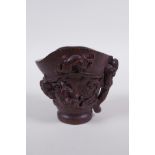 A Chinese carved bamboo libation cup with climbing kylin decoration, impressed seal mark to base,