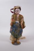 An antique bisque headed doll in Arabian clothing, marked to the back of the neck C10/0, 30cm high