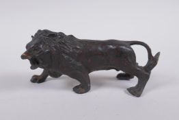 A bronzed and gilt metal lion, 14cm long