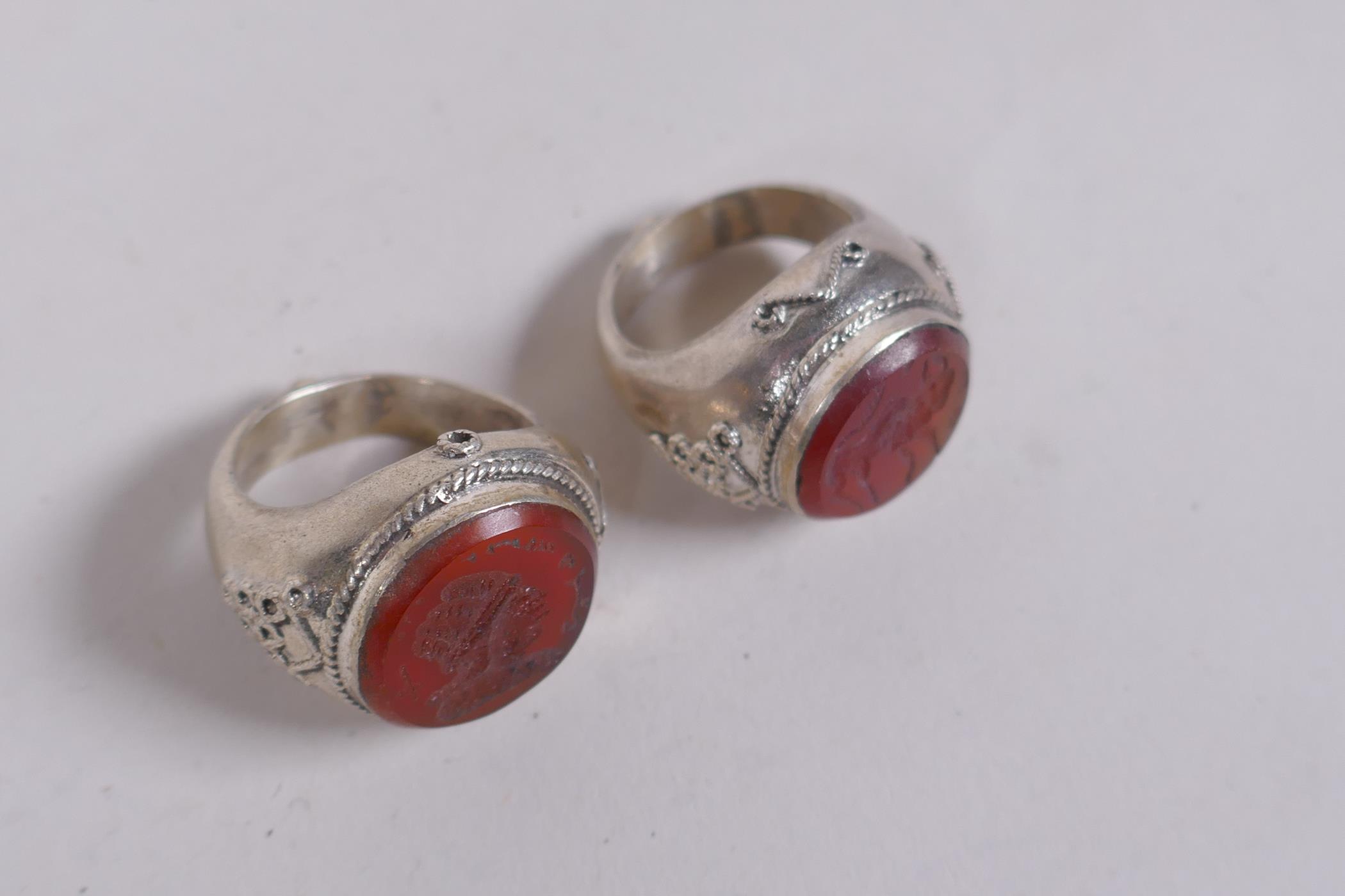 Two Islamic white metal intaglio rings and two similar pendants, largest 4cm diameter - Image 4 of 4