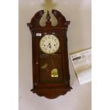 A Howard Miller mahogany cased wall clock, with spring driven movement and Westminster chimes,