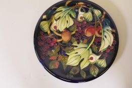 A Moorcroft pottery charger in the Queen's Choice pattern, designed by Emma Bossons, signed BM, in
