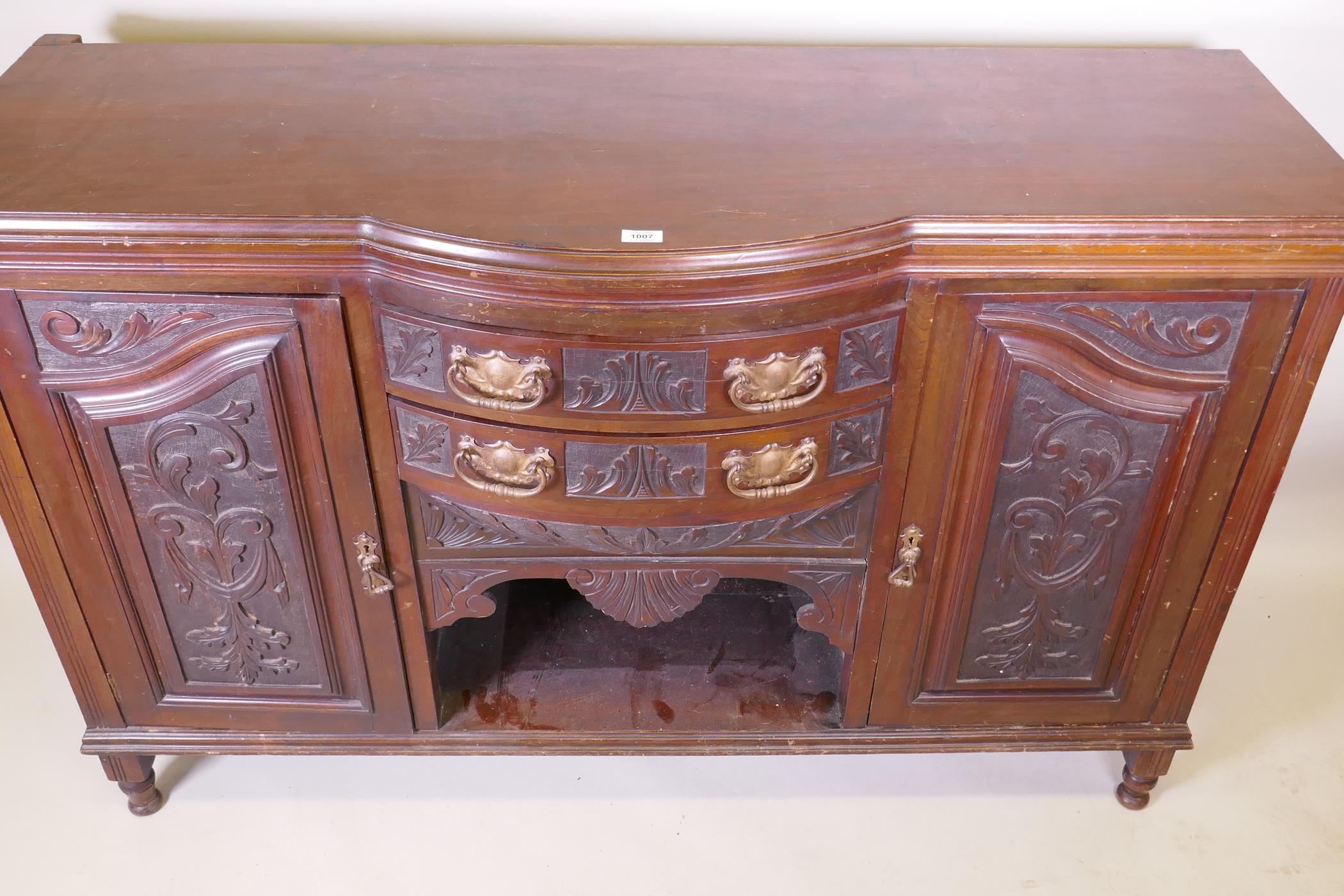 A Victorian walnut sideboard with carved decoration, two cupboards flanking two bow fronted drawers, - Image 2 of 5