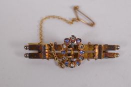 A 15ct gold buckle brooch, set with diamonds and sapphires, 4.2cm long, 3.9g