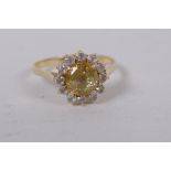 14ct gold ring set with central yellow sapphire surrounded by white sapphires, size N/O