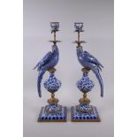 A pair of blue and white porcelain and gilt metal parrot candlesticks
