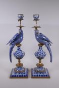 A pair of blue and white porcelain and gilt metal parrot candlesticks