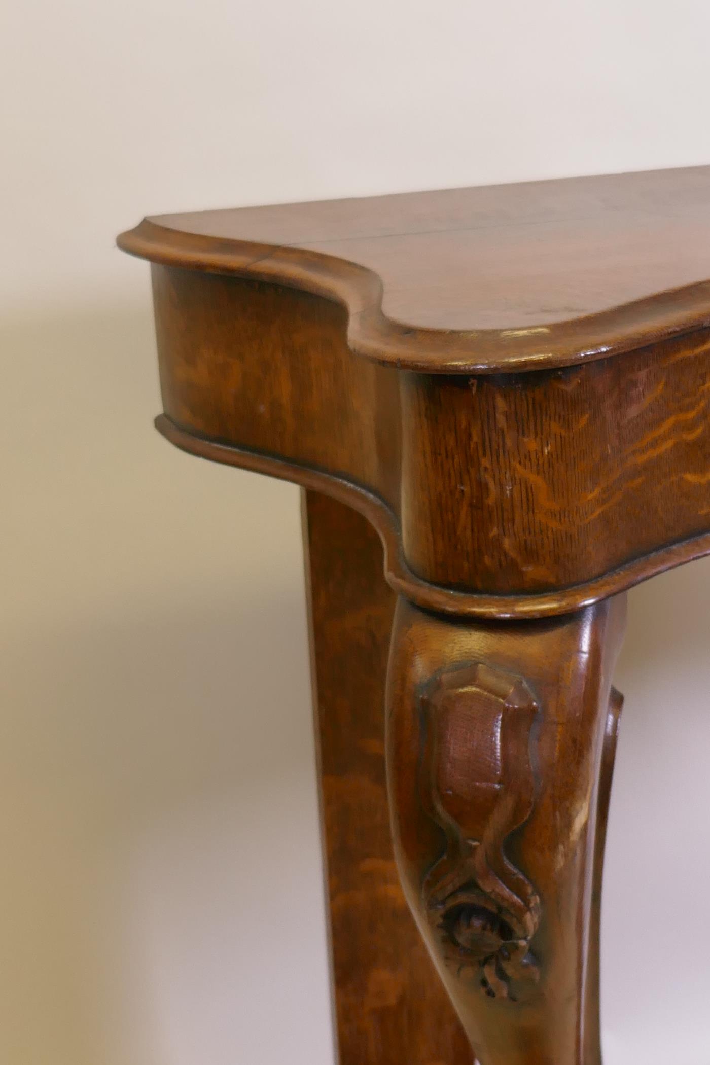 A Victorian oak serpentine console table on carved scrolled cabriole supports united by an under - Image 3 of 4