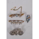 A Victorian silver bicycle brooch, 1896, 3.7g, 4cm long, a silver wishbone brooch with enamelled