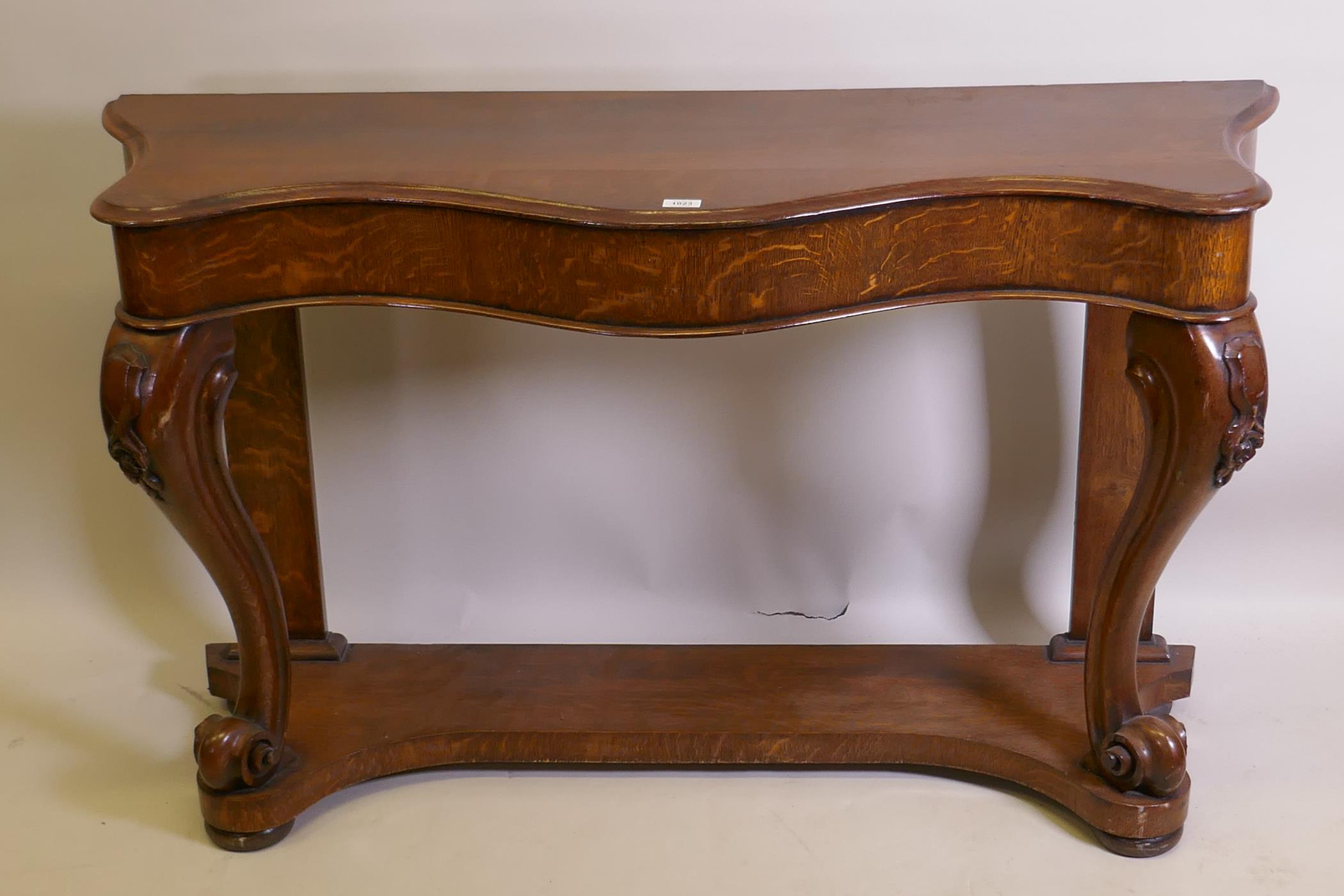 A Victorian oak serpentine console table on carved scrolled cabriole supports united by an under - Image 2 of 4