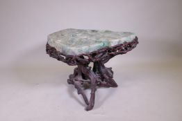 An oriental green quartz/fluorspar top table, raised on a rootwood base, AF, 80 x 65 x 56cm