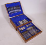 An oak canteen of silver plated King's pattern flatware by James Ryals, 12 settings, lacks carving