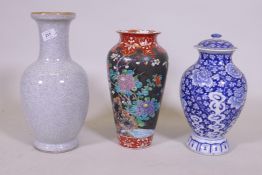 An oriental blue and white jar and cover, 30cm high, a famille noir vase with floral decoration