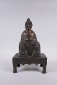 A Chinese gilt bronze figure of Buddha seated on a throne, inscription verso, 26cm high