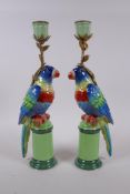 A pair of polychrome porcelain and gilt metal parrot candlesticks, 32cm high